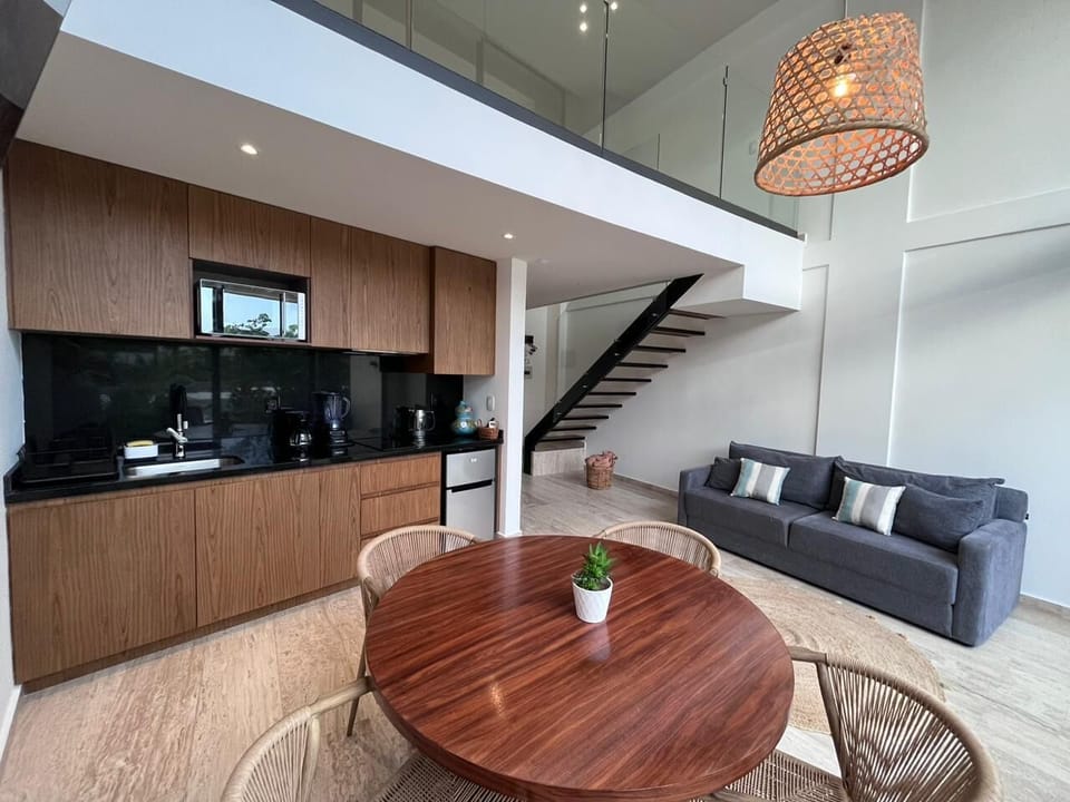 Deluxe Apartment, Pool View | Private kitchen | Fridge, microwave, cookware/dishes/utensils, dining tables