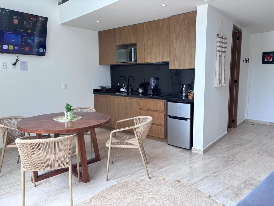 Deluxe Apartment, Pool View | Private kitchenette | Fridge, microwave, cookware/dishes/utensils, dining tables