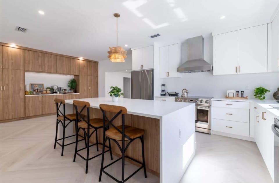 Gather around the oversized island for meals, coffee chats, or evening wine.