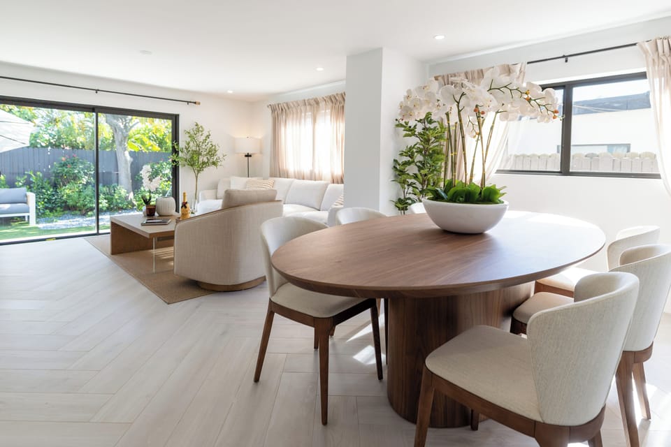 Dine or lounge with serene views of the lush backyard.