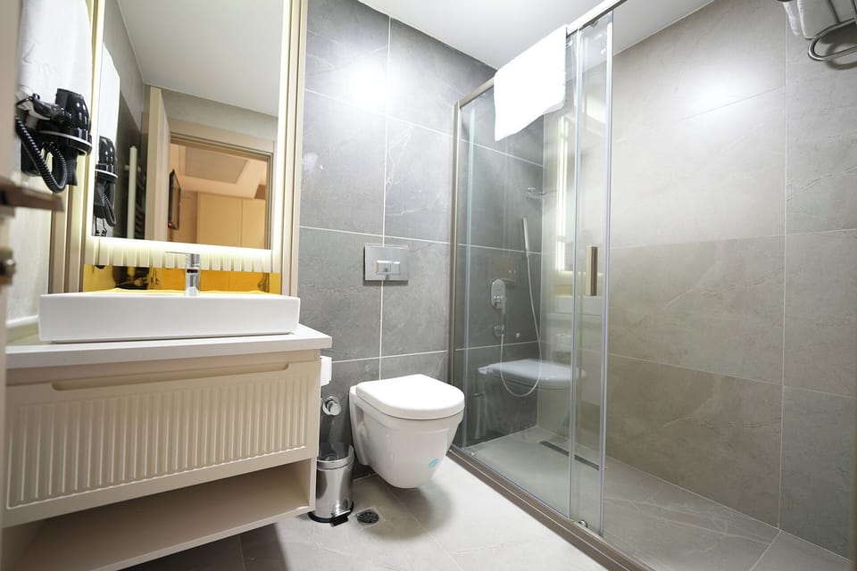 Shower, hair dryer, slippers, towels