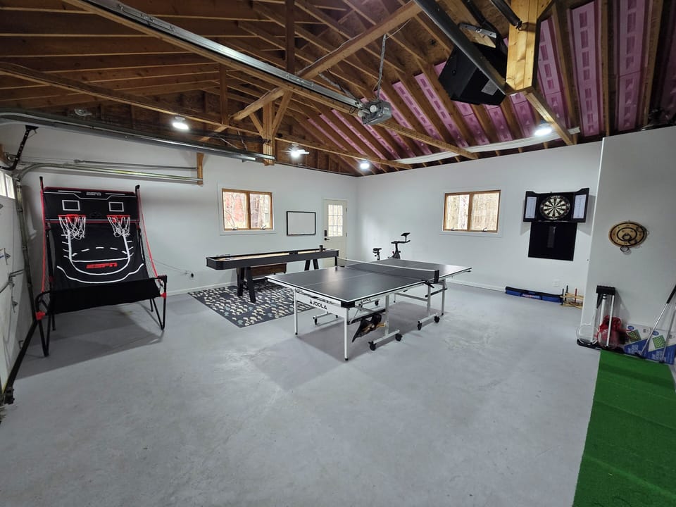 Spacious game room with ping pong, shuffleboard, darts, and more.