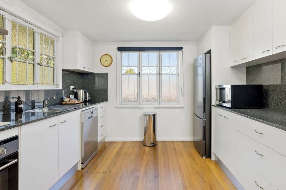 The sleek kitchen is immaculately presented with stainless steel appliances to cook up a feast.
