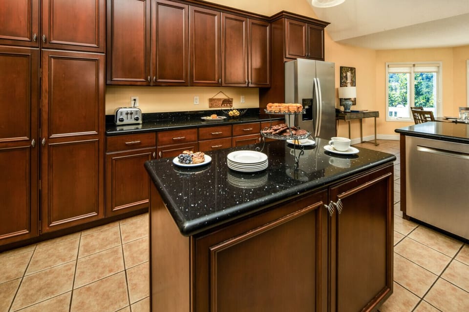 Kitchen | Spacious and fully equipped with modern appliances, granite countertops, and a center island for easy meal prep