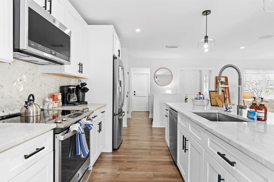 Designed with both beauty and function in mind, this modern kitchen features spacious counters, sleek finishes, and everything needed to cook with ease.