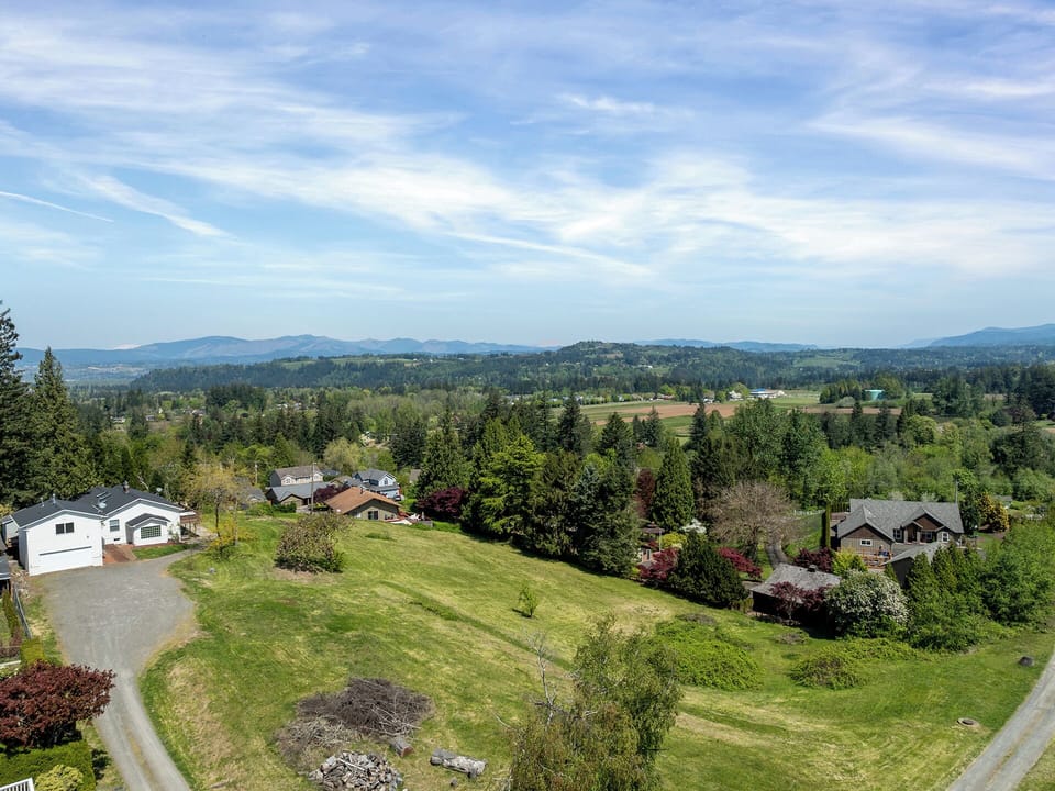 Expansive property layout showing the large open field and surrounding mountains