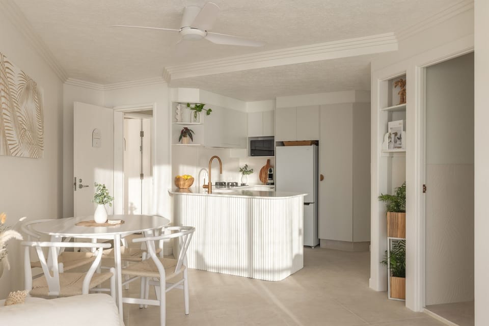 Newly renovated kitchen with full amenities, flowing into a chic dining + lounge area.