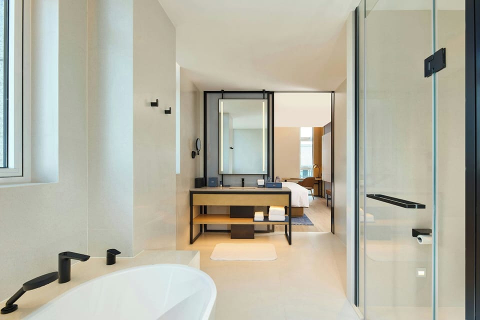 Executive Suite, 1 Bedroom, City View | Bathroom | Hair dryer, bathrobes, slippers, towels