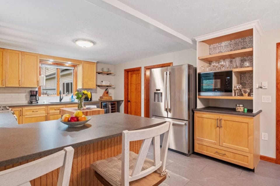 Bright, fully stocked kitchen with modern appliances, island prep space, and everything needed for home-cooked meals.