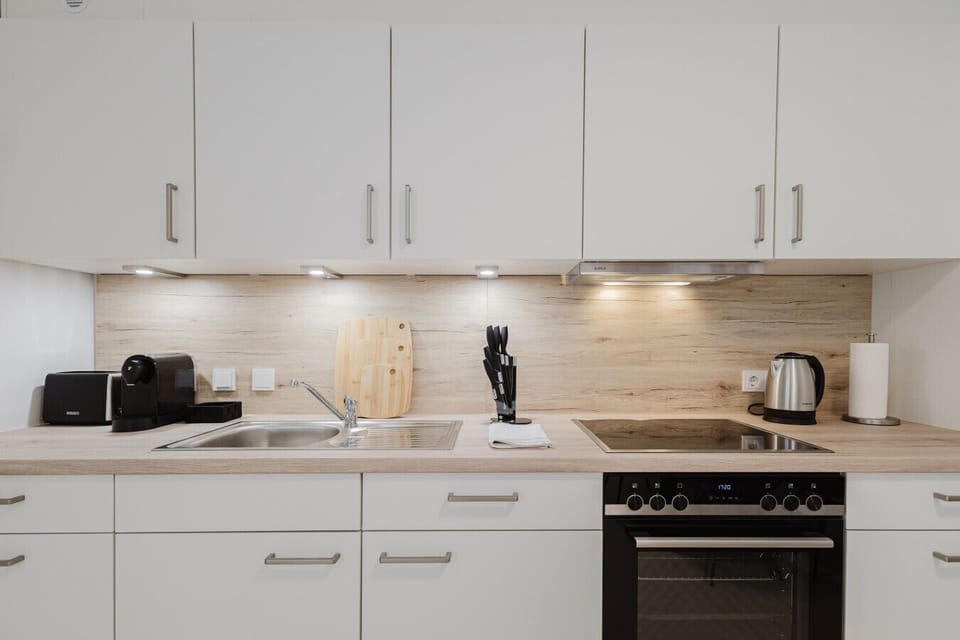 Compact, fully equipped kitchen with modern appliances.