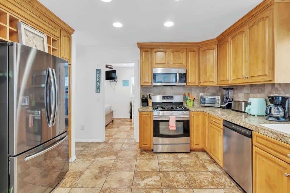 Fully equipped kitchen with an array of appliances including air fryer, ninja blender and more.