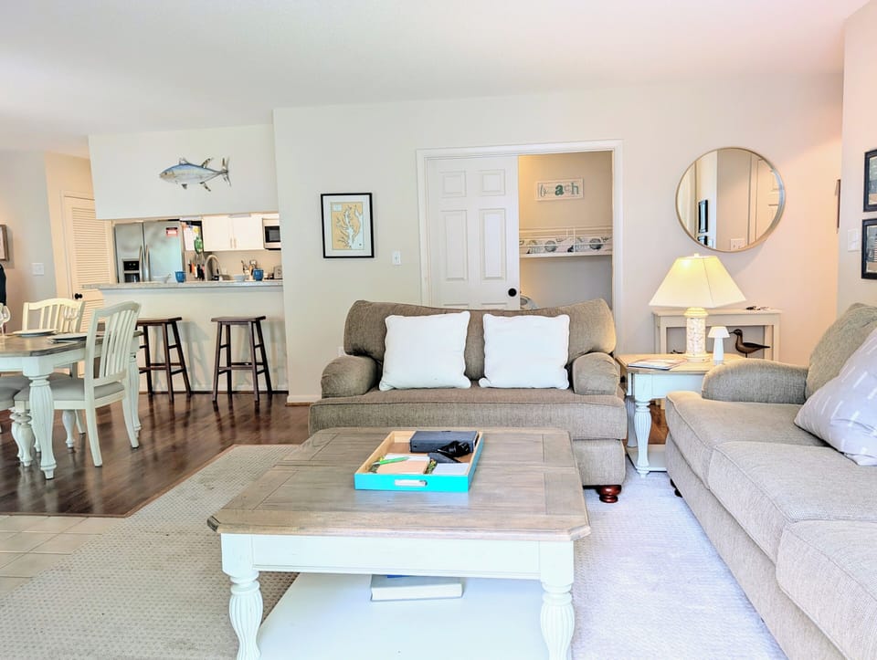 Living Area - Welcome to an inviting, accessible entry into this rare first-floor retreat. Enjoy immediate views across the open-concept living area, where the effortless flow from room to room makes both daily living and entertaining a breeze.