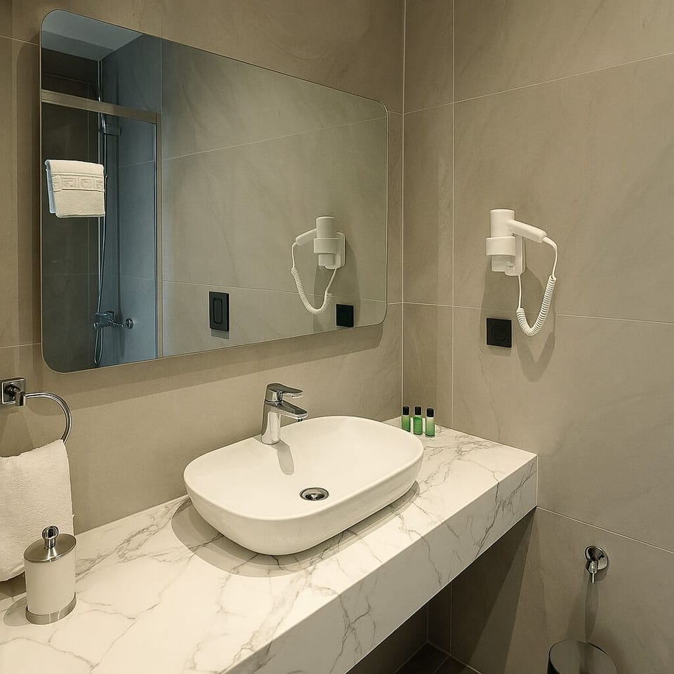 Quadruple Room | Bathroom | Shower, hair dryer, slippers, towels