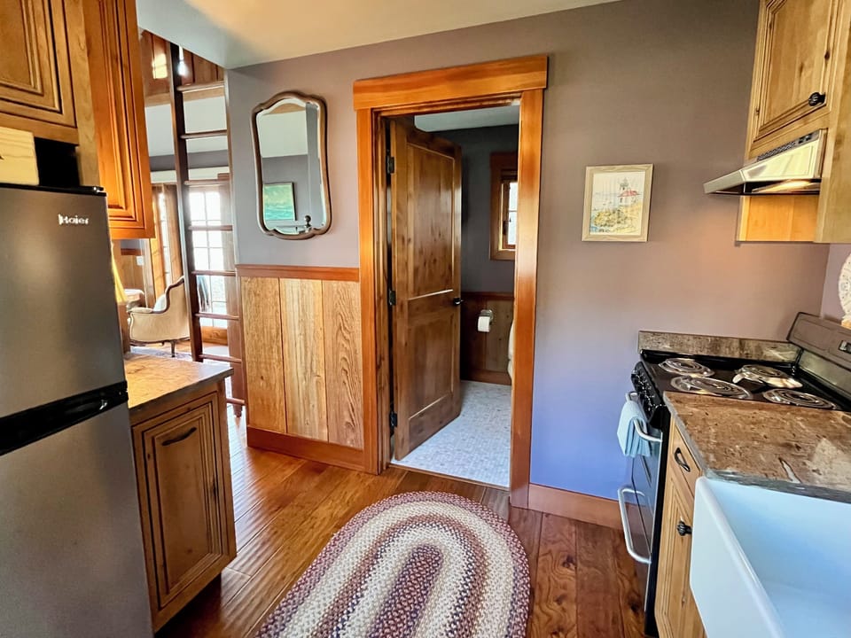 The kitchen opens to the bathroom and bedroom / living space.