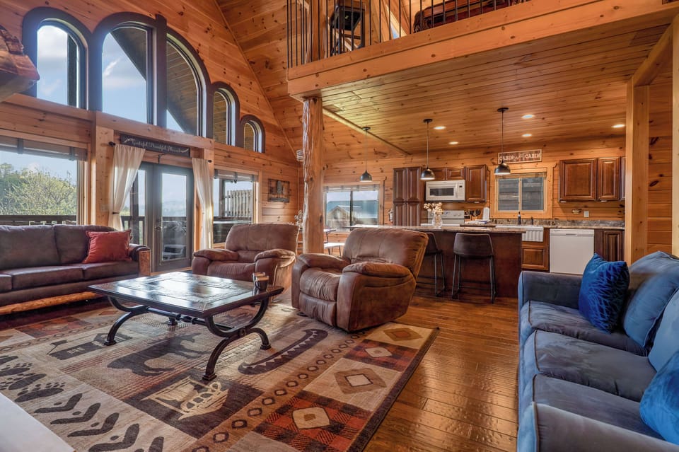 Spacious living room with fireplace,  2 sleeper sofas, & TV.