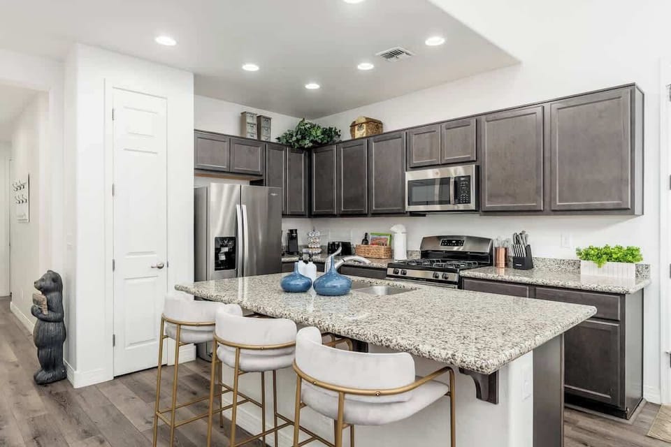 Your spacious kitchen features granite countertops, stainless steel appliances, and a comfortable breakfast bar where you can enjoy morning coffee or quick meals together.