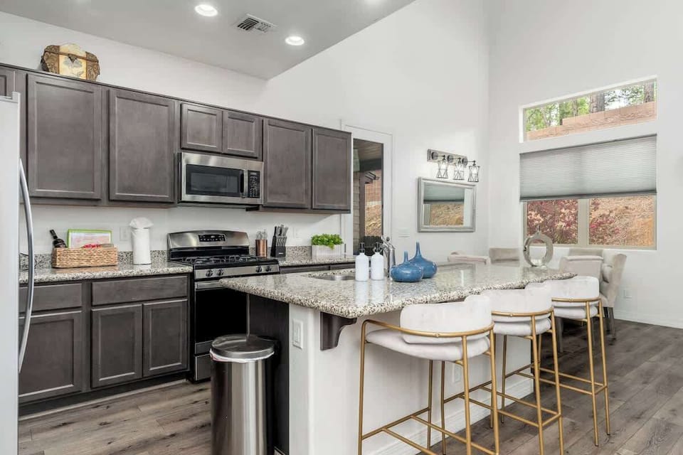 You'll love gathering here—a bright, modern kitchen with granite counters, gas range, and a breakfast bar perfect for morning coffee or casual meals together.