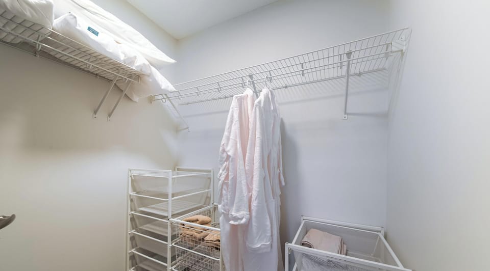 Walk-in closet with robes and storage for longer group stays