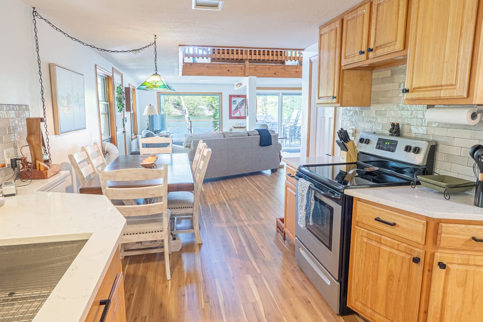 The main floor features an open-concept living, dining, and kitchen area