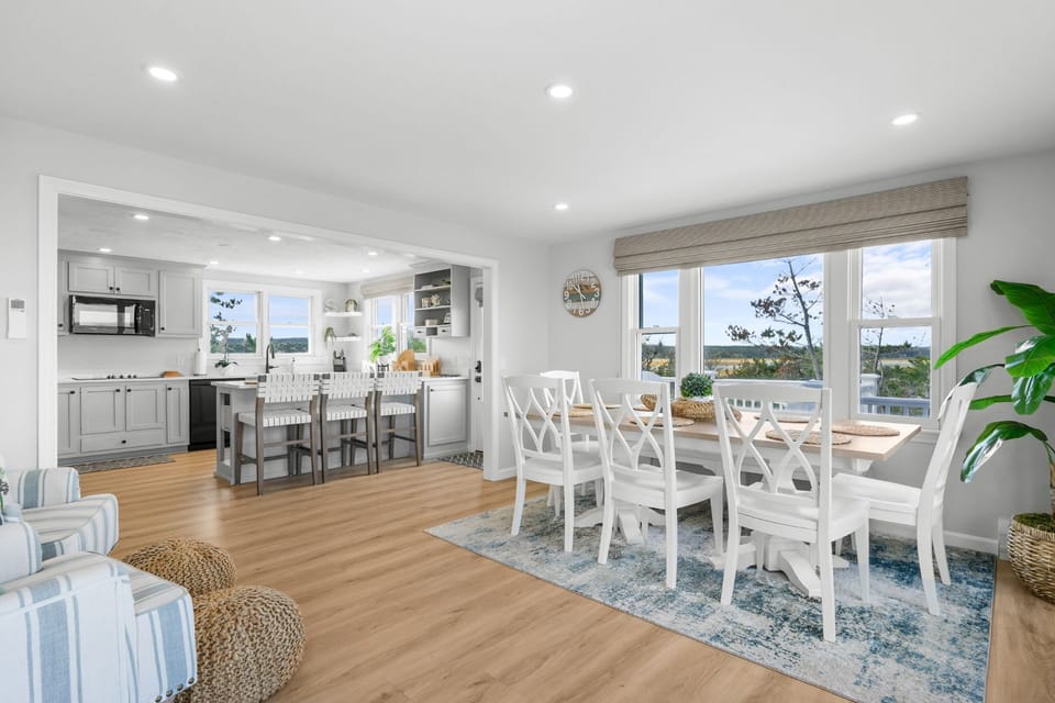 Dining area with seating for 8 people and kitchen island with additional seating