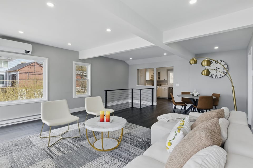 Bright and stylish open-concept living space featuring designer furnishings, a cozy dining nook, and sleek finishes—ideal for entertaining or unwinding. 🏠✨🍷