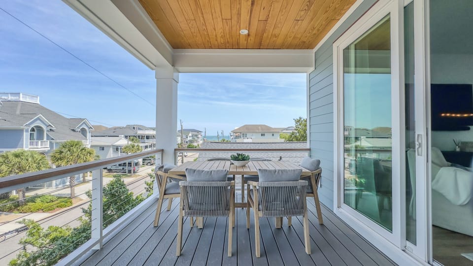 Balcony off living room with partial view of the Atlantic Ocean. Dining for 6!