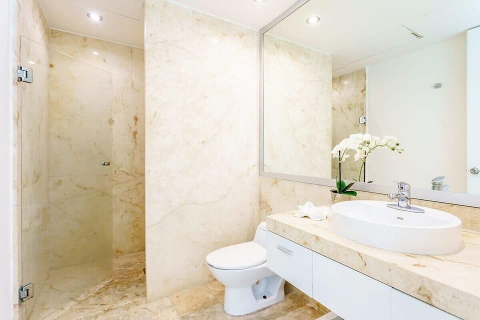 Large shared full marble bath; stylish & functional.