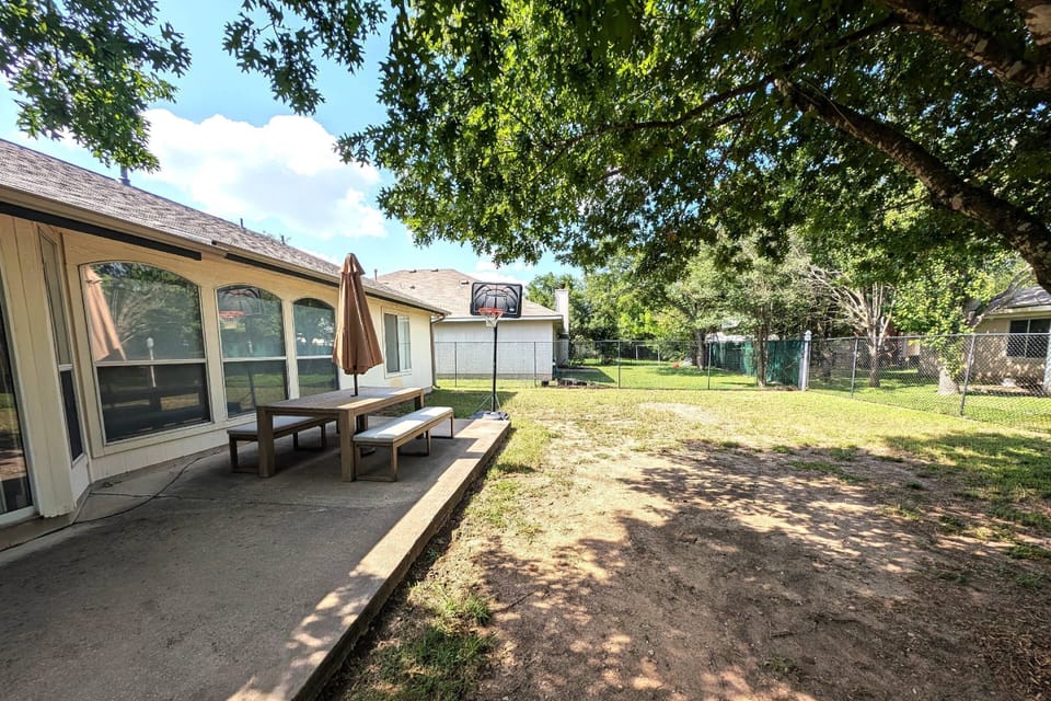Large back yard with BBQ and outdoor seating