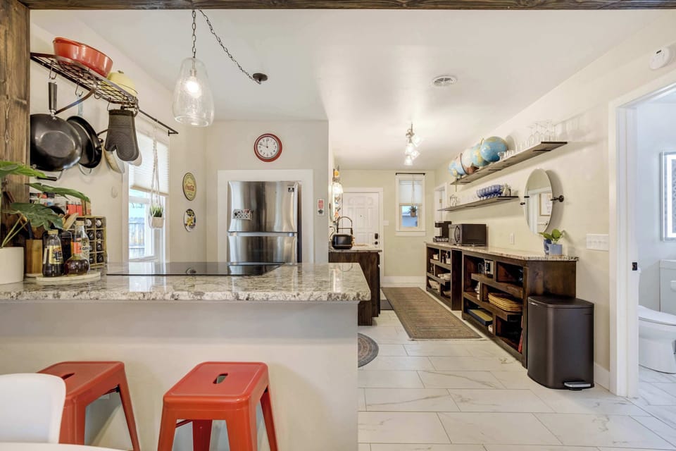 Whip up your favorite meals in a stylish, fully equipped kitchen with granite counters, modern appliances, and rustic flair


