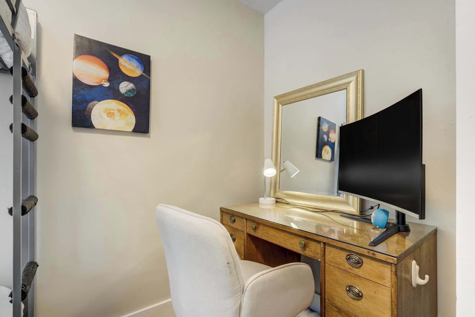 A quiet corner with a vintage desk and Ultra-wide Monitor—ideal for remote work, journaling, or a moment of solitude








