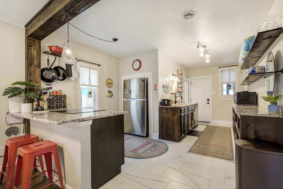 Whip up your favorite meals in a stylish, fully equipped kitchen with granite counters, modern appliances, and rustic flair

