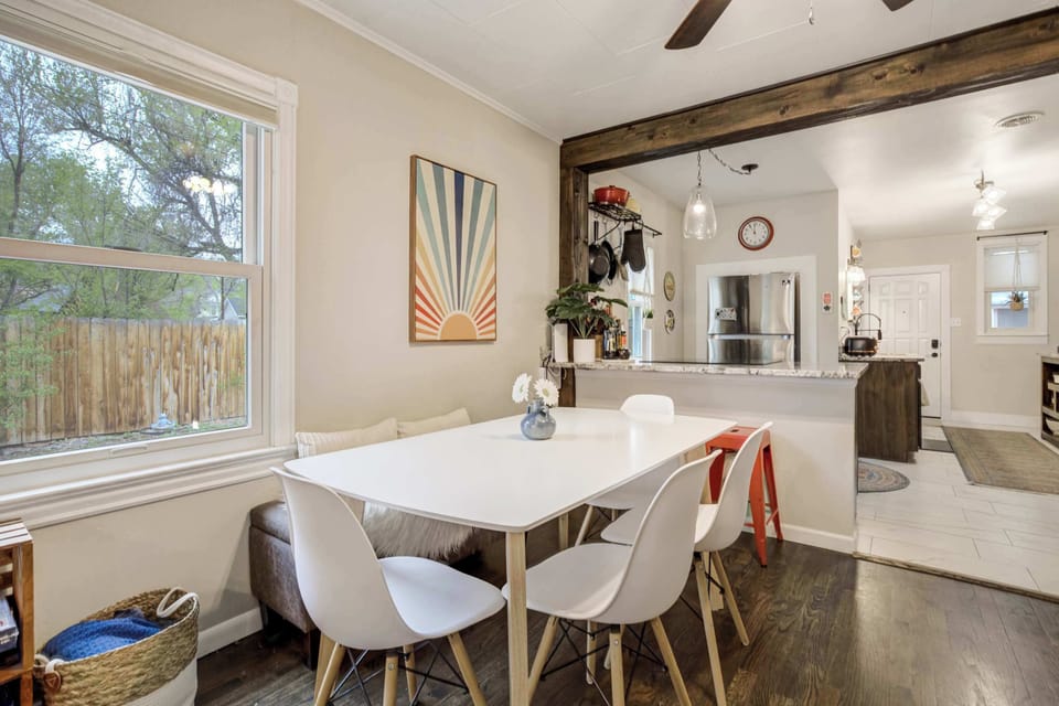 Share meals and morning coffee at the sunlit dining table with views of the backyard and easy access to the kitchen

