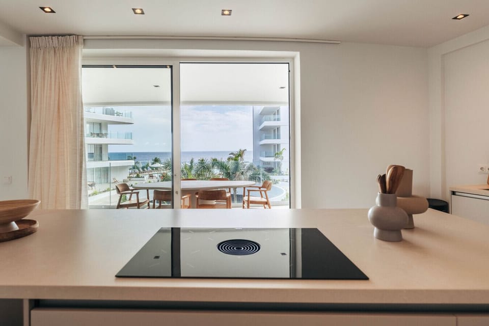 Cook with a view! This is the kitchen of One Mambo 21, featuring a modern stove and breathtaking ocean views right from your countertop.