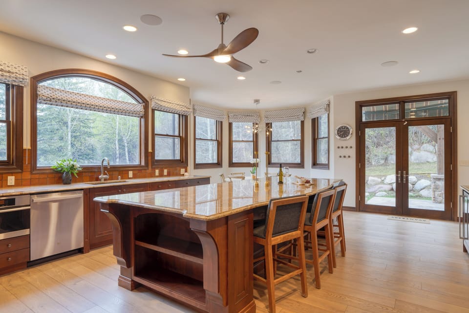 Kitchen features a large island and barstool seating.