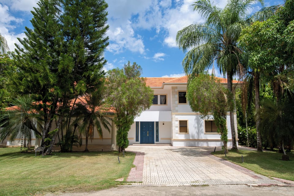 Exterior Oasis: Immerse yourself in vibrant greenery and stunning blue skies at our villa!