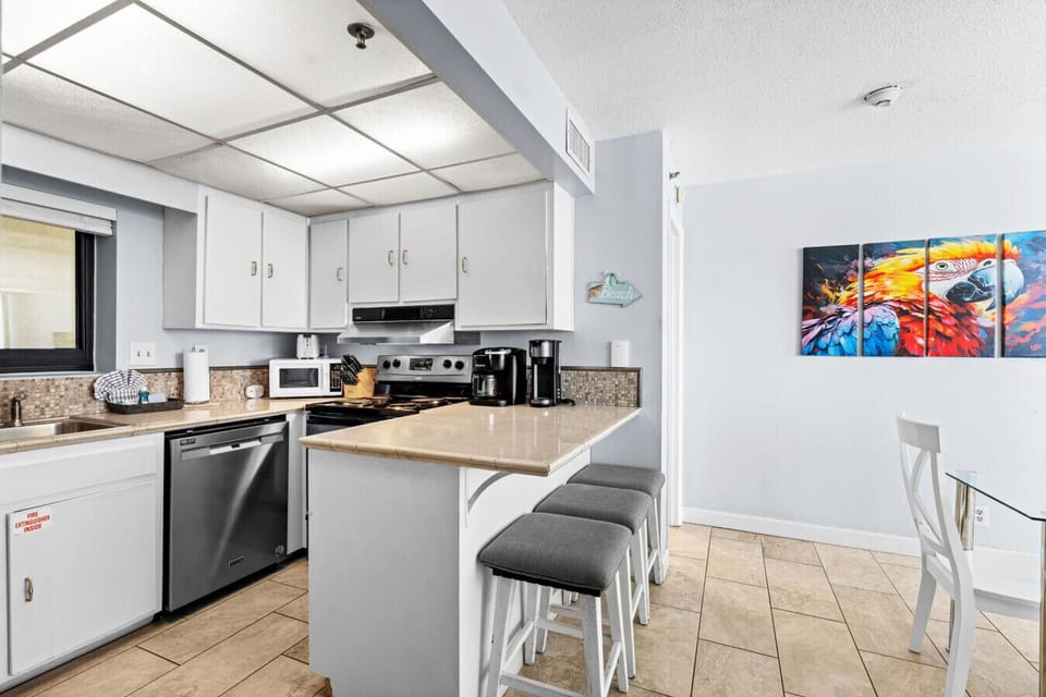 Whip up meals in the fully stocked kitchen, then dine just steps away beneath vibrant beach-themed art.