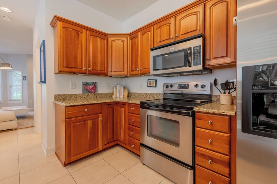 Fully stocked kitchen with stainless steel appliances, stove, and everything needed for family cooking.