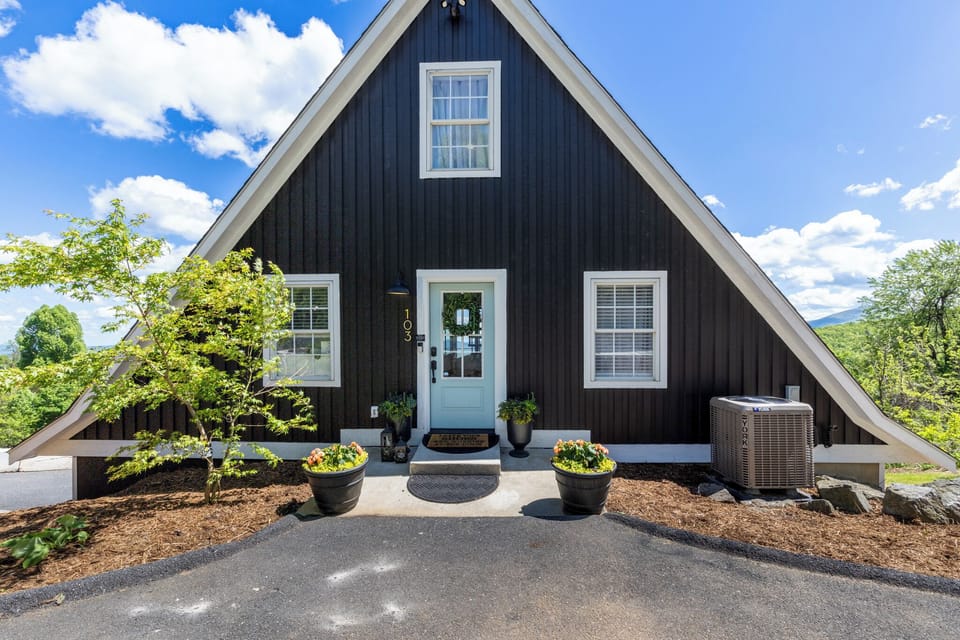 From this angle, the symmetry of the A-frame is stunning — showcasing the perfect balance between rustic charm and sleek modern design, framed by panoramic mountain views.