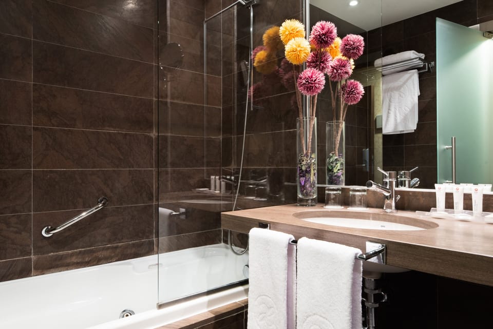 Bathtub, eco-friendly toiletries, hair dryer, towels