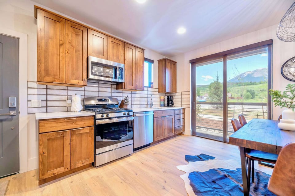 Fully Equipped Kitchen With Modern Appliances And Natural Wood Finishes