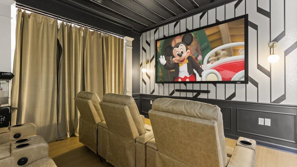Newly renovated mickey-mouse themed in-home movie theater with large projector screen