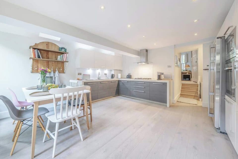 Ground floor - large space with a modern and fully equipped kitchen, a dining area, and a TV. Leads to the terrace at the back of the property
