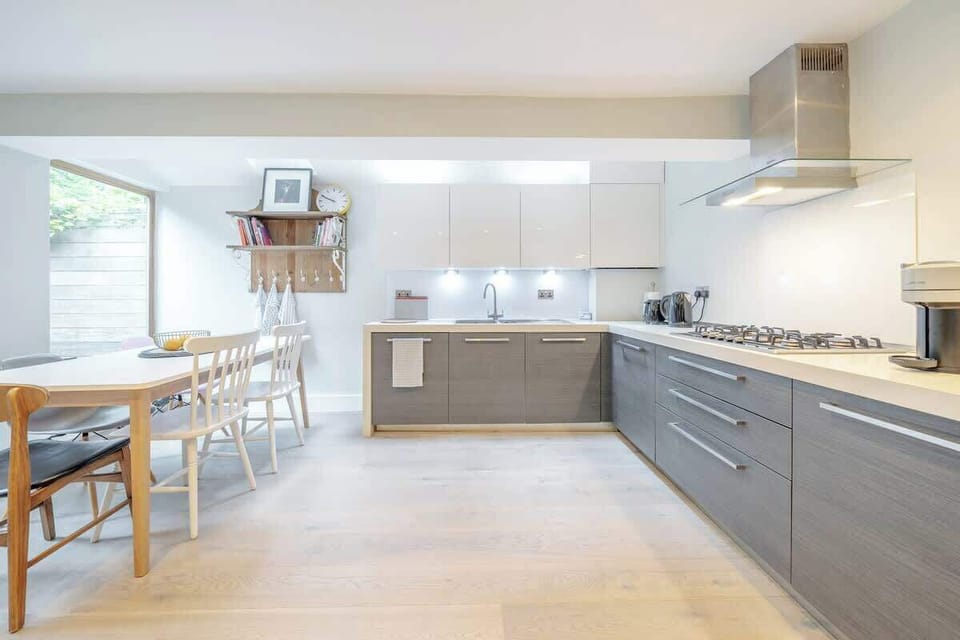 Ground floor - large space with a modern and fully equipped kitchen, a dining area, and a TV. Leads to the terrace at the back of the property