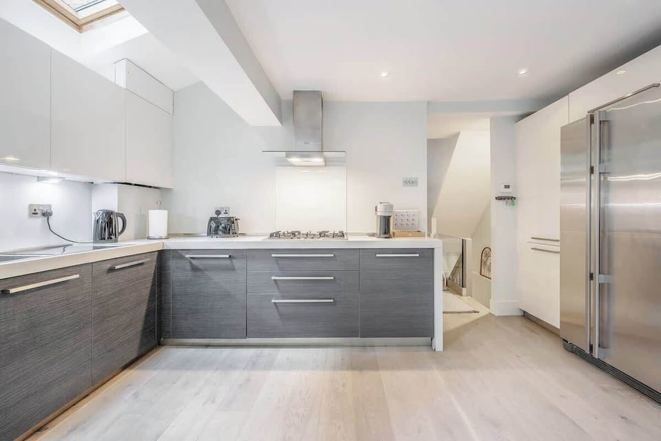 Ground floor - large space with a modern and fully equipped kitchen, a dining area, and a TV. Leads to the terrace at the back of the property