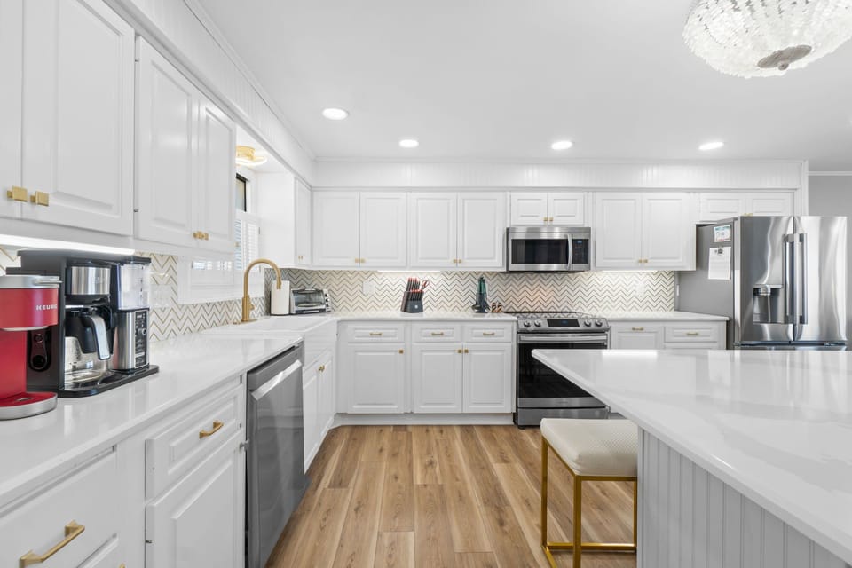 Soft lighting and coastal accents tie the kitchen into the overall design, creating a warm, welcoming space that's as functional as it is beautiful.