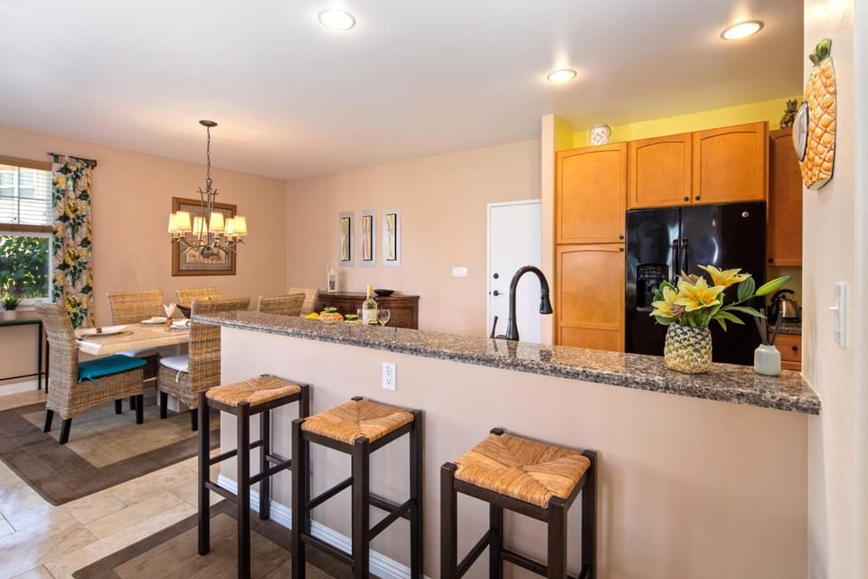 Modern kitchen with granite counters and bar seating for casual bites WCV-305