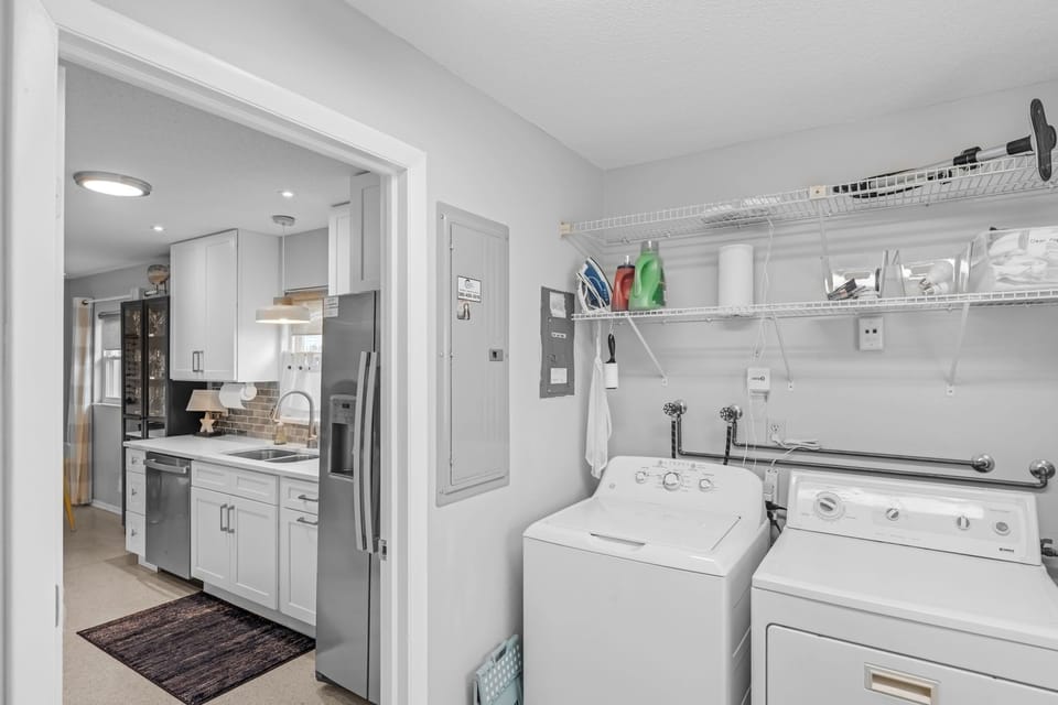 Full indoor laundry room with washer and dryer