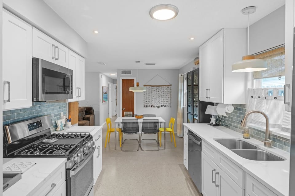 Gourmet kitchen with gas stove, dishwasher, microwave, coffee makers, toaster