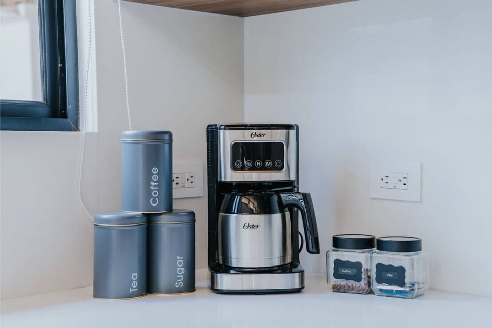 A beautifully curated coffee & tea station featuring a coffee maker, Costa Rican coffee, teas, and sugar—perfect for slow mornings and enjoying life’s simple pleasures.