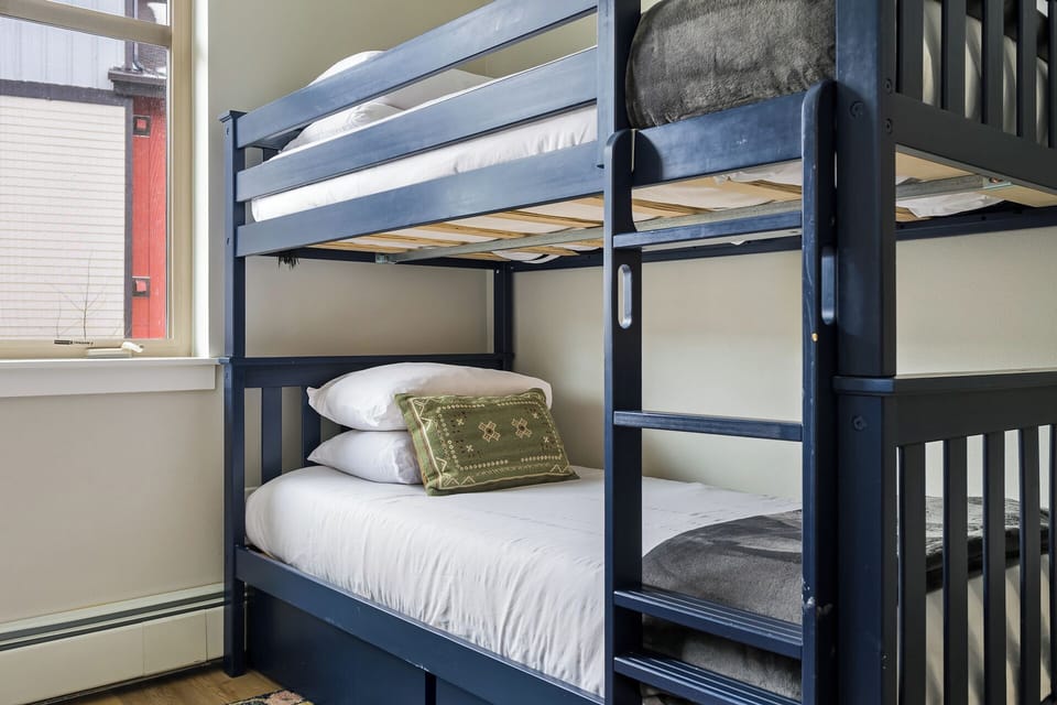 Twin over Twin bunk beds with hotel-style luxury linens in the second bedroom